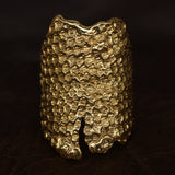 Bearded Dragon Armour Ring front shot, in 18 karat yellow gold. Lying on leather - CLIO SASKIA